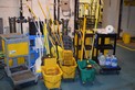 LOT OF JANITORIAL EQUIPMENT - BROOMS, MOP BUCKETS, MOPS, CLEANERS, ROLLING CARTS