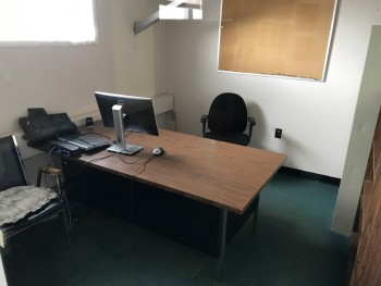 Office with Desk, Chair, and Shelf. No File Cabinets or Electronics