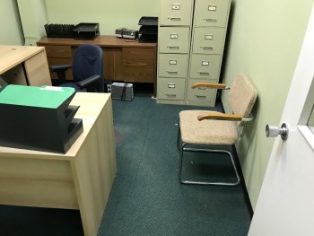 Office with Desk, Chair, and Shelf. No File Cabinets or Electronics