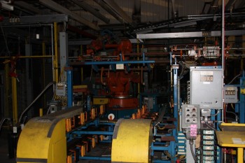 Robot cell complete with run up conveyor, robots, robot tooling, control panels
